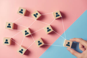 building strong team wooden blocks with people icon blue pink background human resources management concept 1 1 300x200 1 1