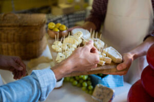 staff showing sample cheese customer counter 1 1 300x200 1 1
